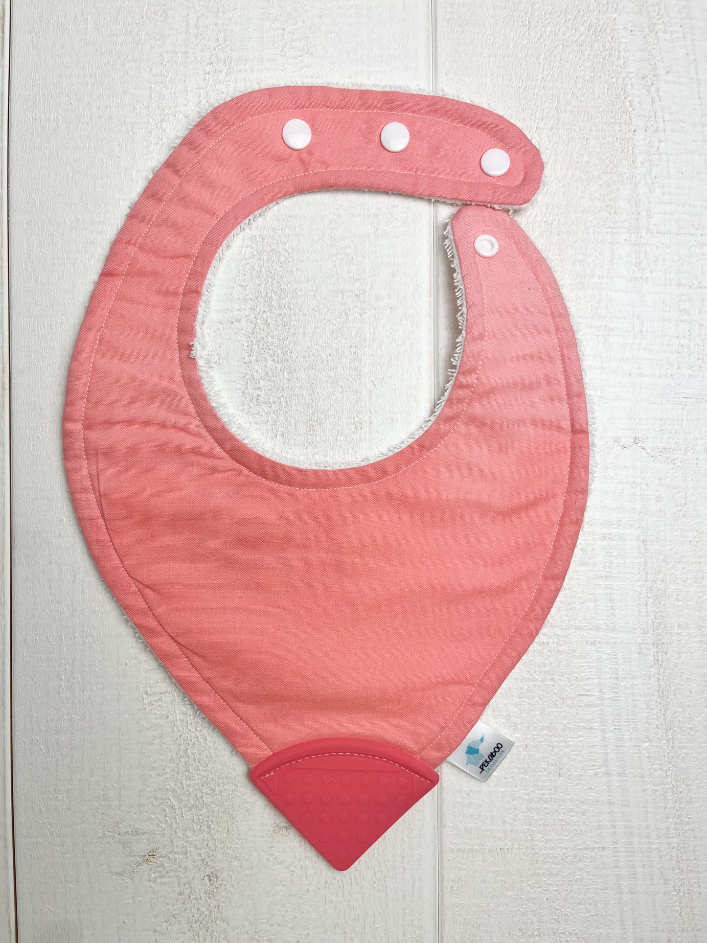 Bavoir dentition - Rose (l'attache est sens contraire habituel et plus grand)