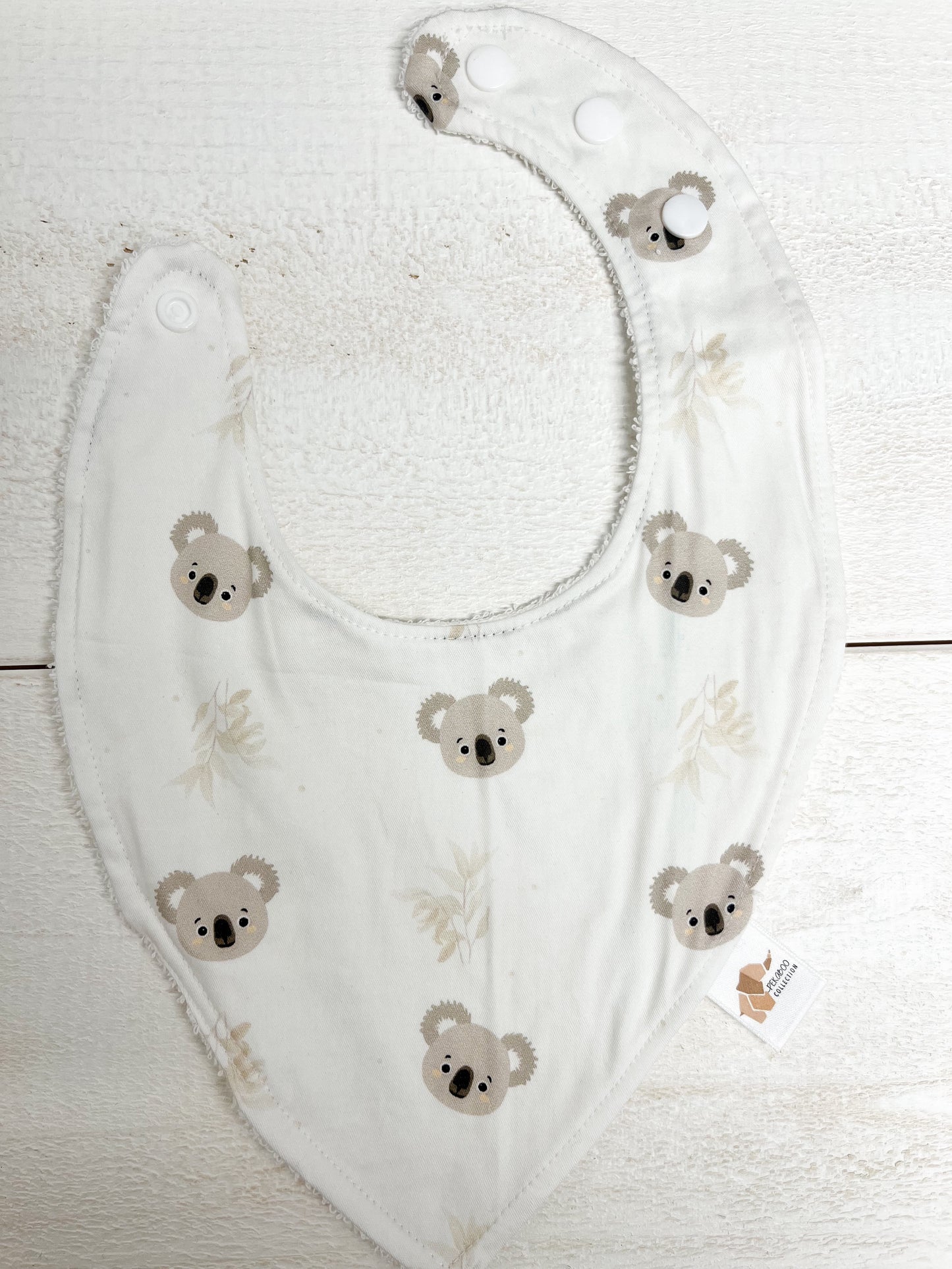Bavoir - Koalas et feuillus beige (Tache d'encre bleu)