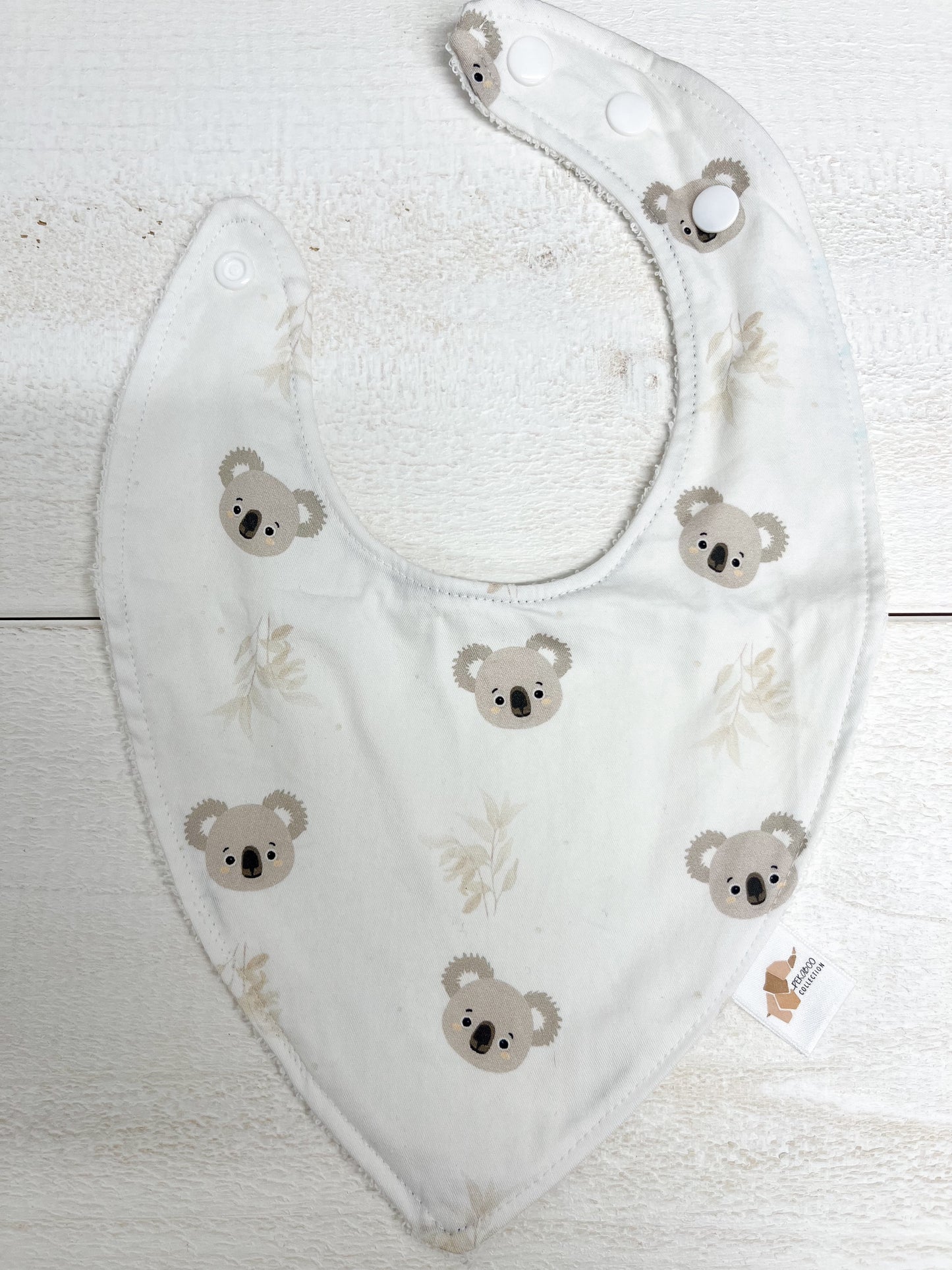 Bavoir - Koalas et feuillus beige (Tache d'encre bleu)