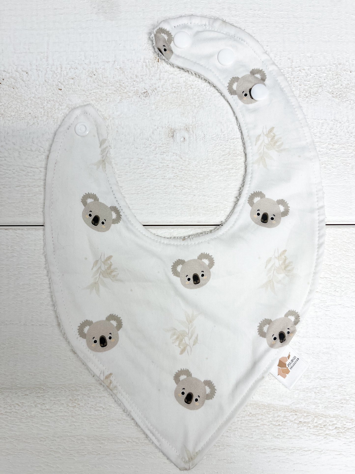 Bavoir - Koalas et feuillus beige (Tache d'encre rouge)